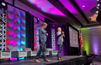 Jordan and Peter speaking on stage